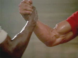 handshake/arm wrestling between Arnold Schwarzeneggar and Carl Weathers in PREDATOR