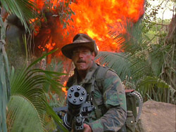 Predator movie Blain unleashes Ole Painless on the guerilla camp with a massive explosion behind him