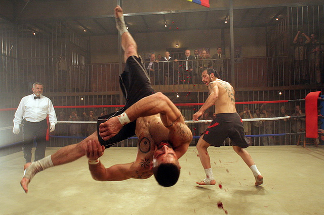 Scott Adkins as Yuri Boyka upside down, blood flying, in the ring in Undisputed III: Redemption fighting Marko Zaror as Raul 'Dolor' Quinones