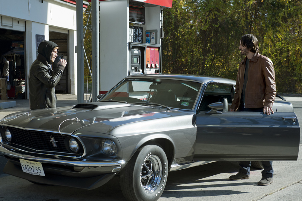 Alfie Allen and Keanu Reeves in John Wick movie talking at gas station about 1969 Mustang Mach 1