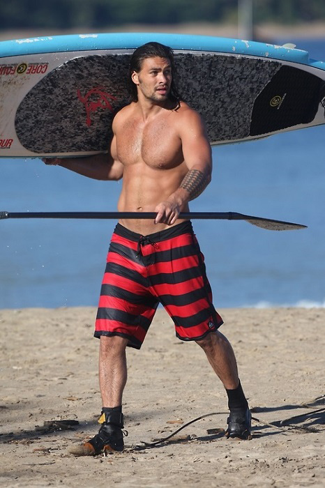 Jason Momoa with surfboard and paddle