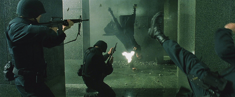 Keanu Reeves as Neo in The Matrix shoots while doing a cartwheel