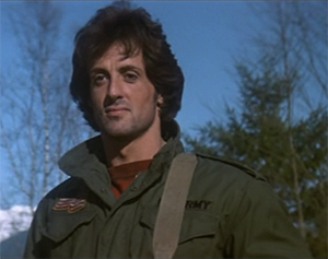Sylvester Stallone as Rambo smiling in the opening of First Blood