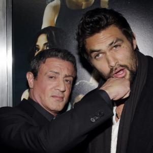 Sylvester Stallone pretend punches Jason Mamoa for a promotional shot for Bullet to the Head