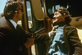 Clint Eastwood as Inspector Callahan points gun at serial killer in front of school bus in Dirty Harry