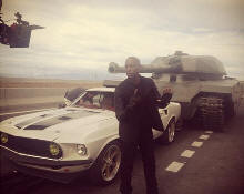 Tyrese Gibson with a tank and a Mustang from Fast & Furious 6