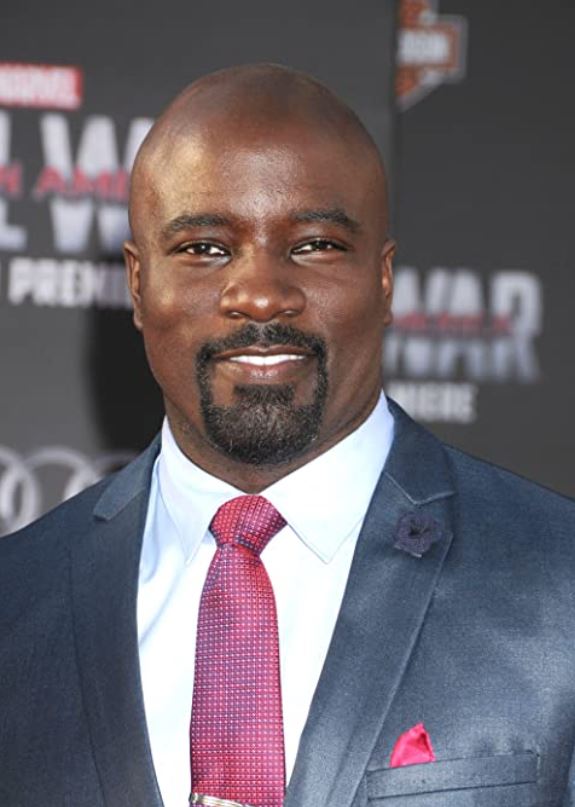 Mike Colter in a suit and tie