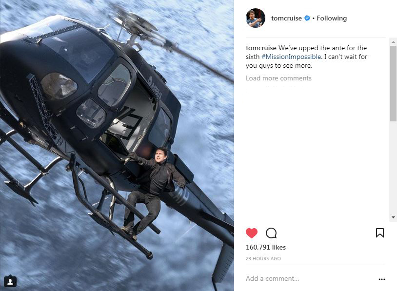 Tom Cruise's second photo on instagram, riding on the outside of a helicopter