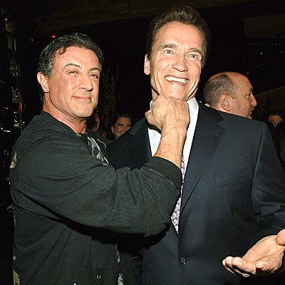 Sylvester Stallone pretends to punch Arnold Schwarzenegger