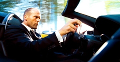 Jason Statham as The Transporter driving a car
