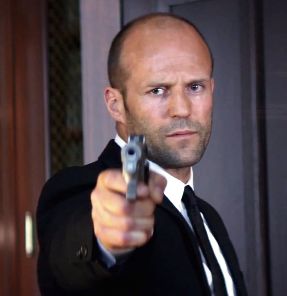Jason Statham as Parker in the moment of ultimate retribution looking a little sad as he's about to shoot the head mobster